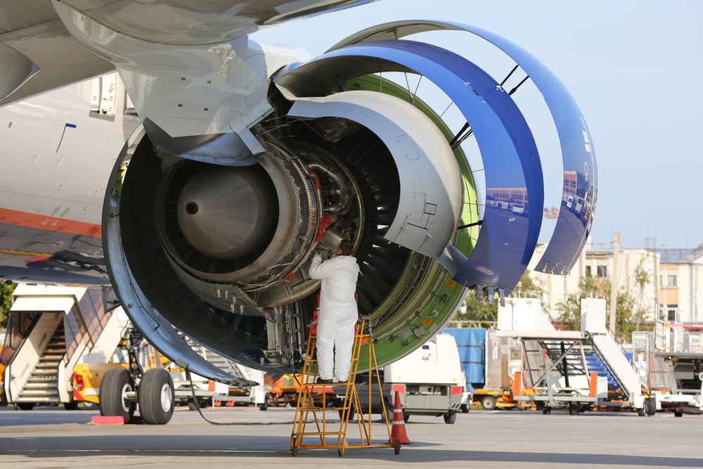 Mechanic servicing jet engine